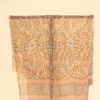 A very soft an elegant shawl in beige color with pink details.