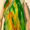 A very soft an elegant shawl in green color with multicolor details.