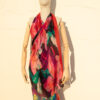 A very soft an elegant shawl in red color with multicolor details.