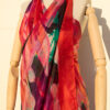 A very soft an elegant shawl in red color with multicolor details.
