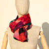 A very soft an elegant shawl in red color with multicolor details.