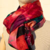 A very soft an elegant shawl in red color with multicolor details.
