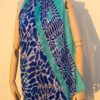 A very soft an elegant shawl in blue color with white and turquoise details.