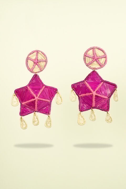 Handmade Iraca palm leaf earrings in vibrant fuchsia star design, boho resortwear jewelry for women.