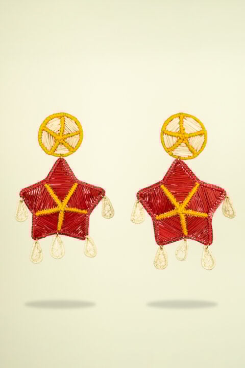 Handmade Iraca palm leaf earrings in bold red star design, boho resortwear jewelry for women.
