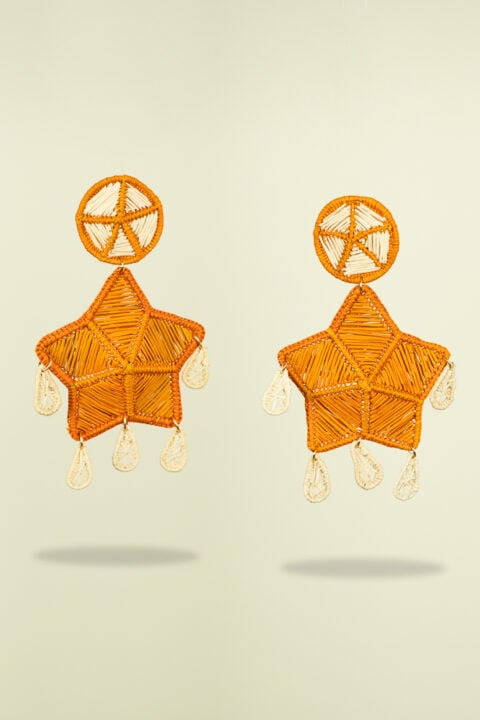 Boho chic Iraca palm leaf earrings in sunset orange, sustainable handmade accessories for resortwear looks.