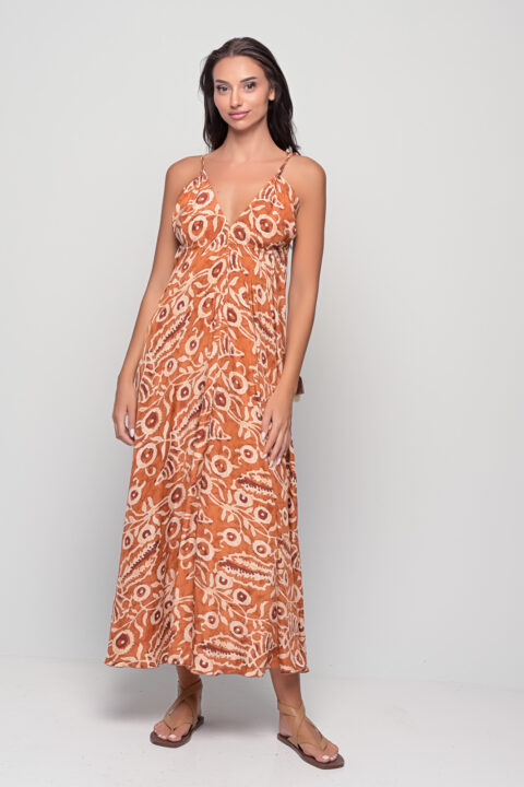 Model wearing open back adjustable maxi dress in Dabu Cinnamon print, front view.