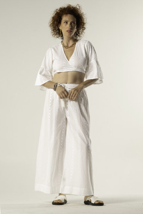 Model wearing Anna Wide-Leg Trousers – white cotton embroidered pants with elastic waist and relaxed fit
