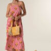 Model wearing Natali Midi Lemon Dress – pink cotton striped dress with lemon print and open tie back