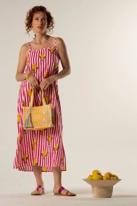 Model wearing Natali Midi Lemon Dress – pink cotton striped dress with lemon print and open tie back