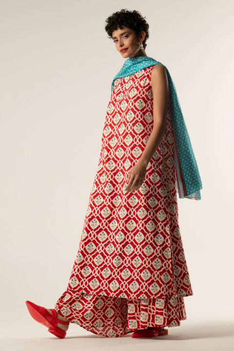 Model wearing Calliope Dress in red triangular cotton print