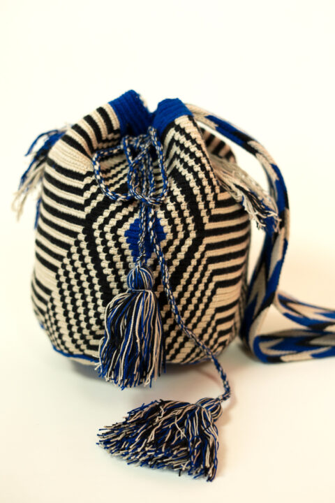 Handmade Wayuu bag – black and blue woven shoulder bag with tassels crafted by Wayuu artisans in Colombia