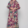 Model wearing Ikaria long cotton dress in Alpinia Purple print with button-down front