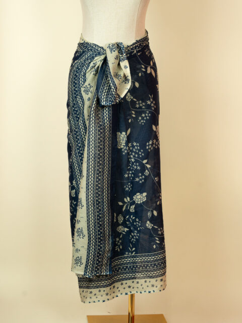 navy blue floral cotton pareo tied as wrap skirt on mannequin