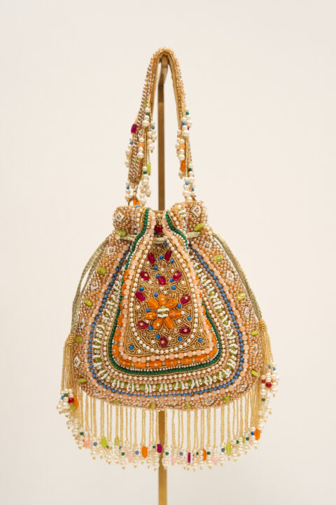 Handmade crystal and beaded embroidered pouch bag with multicolored embellishments and fringe.