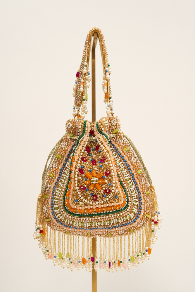 Handmade crystal and beaded embroidered pouch bag with multicolored embellishments and fringe.