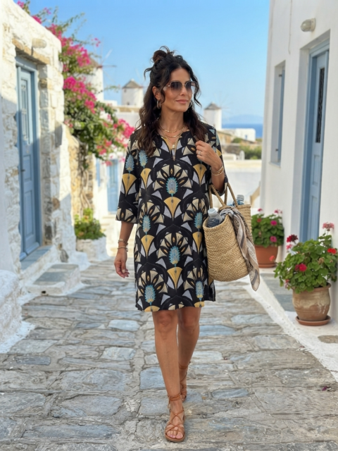 Titli cotton tunic with peacock print in black, gold, and blue, featuring a relaxed fit, V-neckline, and three-quarter sleeves.
