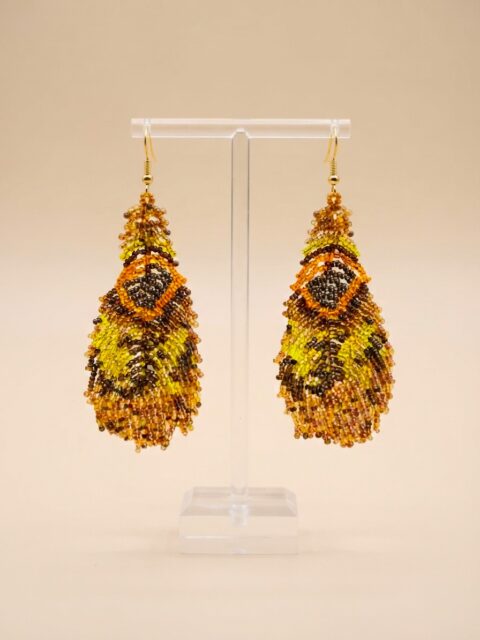 Handmade Colombian beaded earrings inspired by a peacock feather